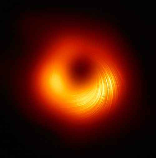 The Event Horizon Telescope (EHT) collaboration, who produced the first ever image of a black hole released in 2019, has today a new view of the massive object at the centre of the Messier 87 (M87) galaxy: how it looks in polarised light. This is the first time astronomers have been able to measure polarisation, a signature of magnetic fields, this close to the edge of a black hole.  This image shows the polarised view of the black hole in M87. The lines mark the orientation of polarisation, which is related to the magnetic field around the shadow of the black hole.